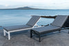 Two powder-coated aluminium sun loungers side by side by the beach with sunbrella cushions