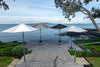 Four Market Umbrellas with different coloured canopies in situ by the beach