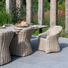 In situ photograph of a dining set featuring Julia outdoor wicker dining armchair