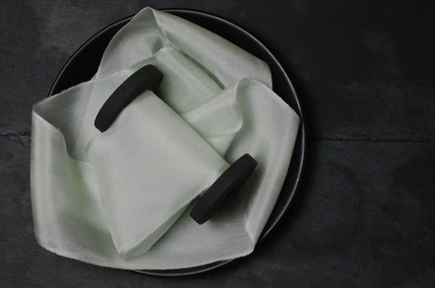 Pistachio Mint Green Silk Ribbon on a large wooden spool