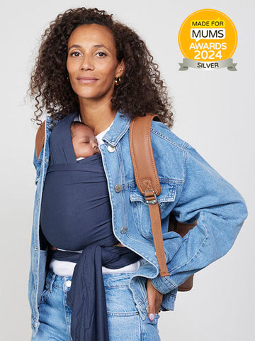 Woman carries baby in Izmi Baby Wrap