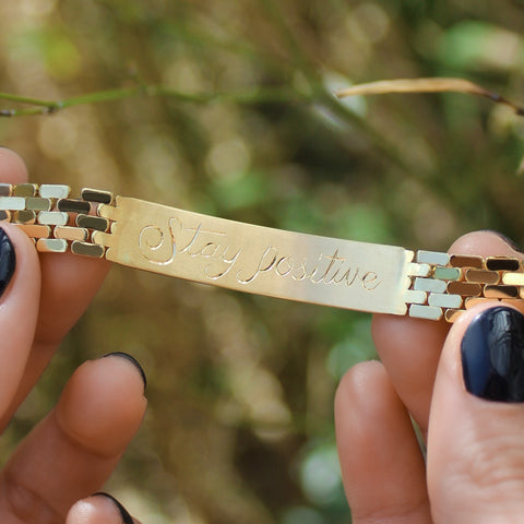 image of 18k yellow gold ID bracelet view from the inside a hidden msg to Stay positive 