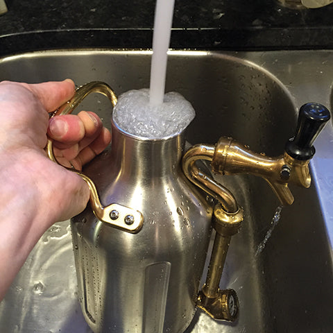 Remove cap and rinse uKeg with hot water