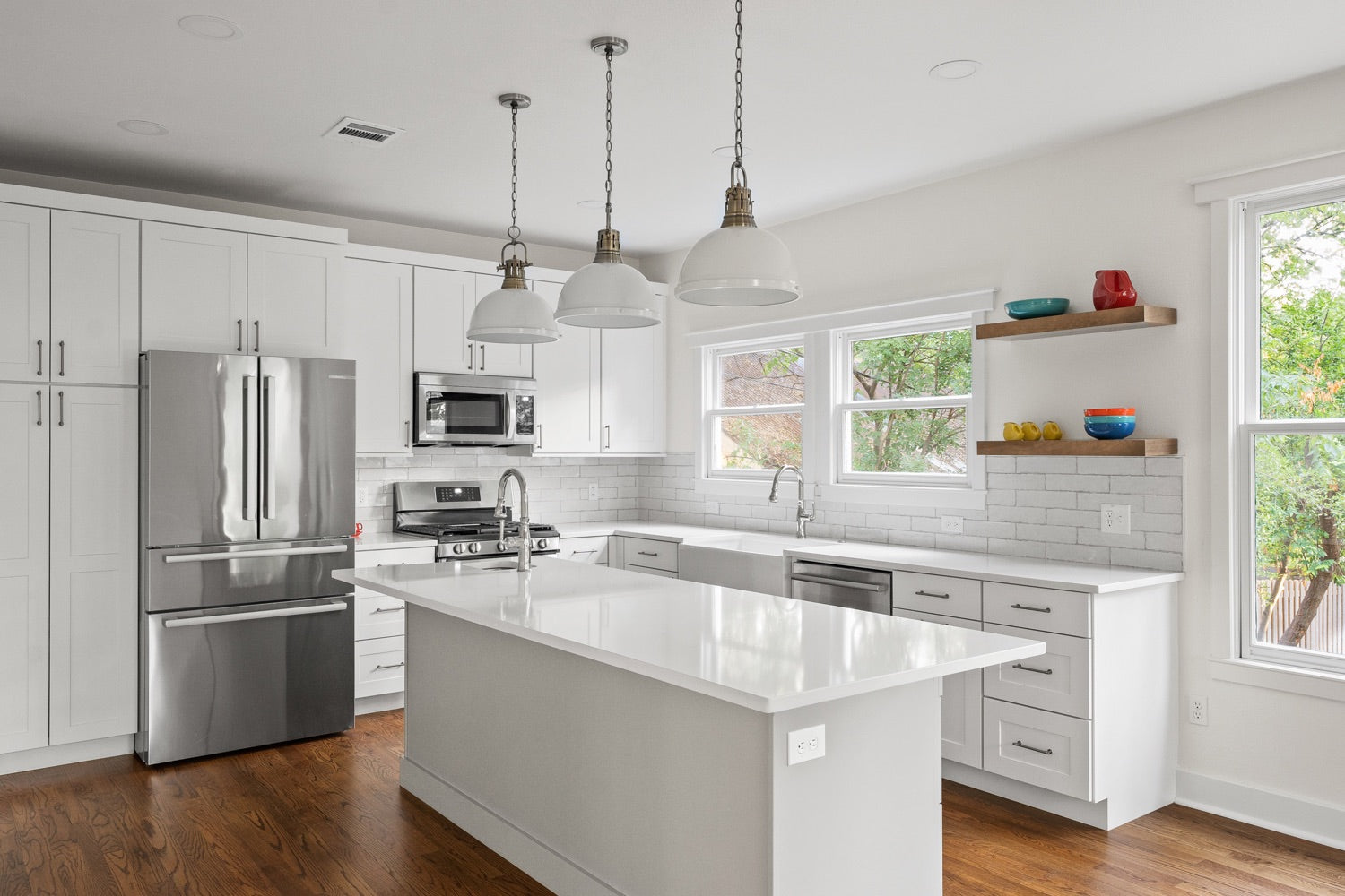 An all-white kitchen in Austin, Texas, showcasing a clean and bright design aesthetic. The kitchen features white cabinetry, countertops, and backsplash, creating a pristine and minimalist look. The natural light fills the space through large windows, illuminating the white surfaces and enhancing the sense of openness. The kitchen may include stainless steel appliances, a spacious island with seating, and sleek pendant lights. The all-white color scheme creates a timeless and refreshing atmosphere, perfect for culinary creativity and gatherings with family and friends. This all-white kitchen in Austin, Texas, combines modern elegance with a touch of Southern charm.