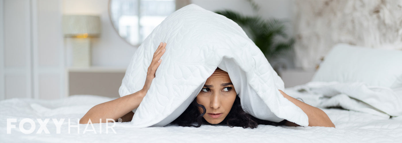 Woman sleeping with clip-in extensions