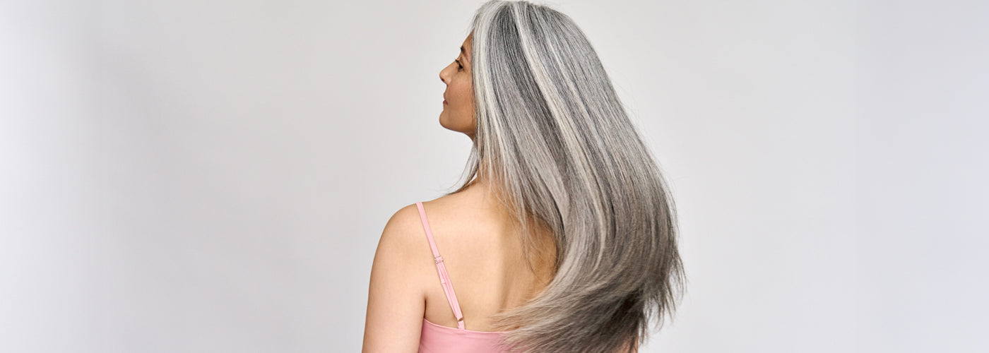 Woman with natural hair applying clip in hair extensions