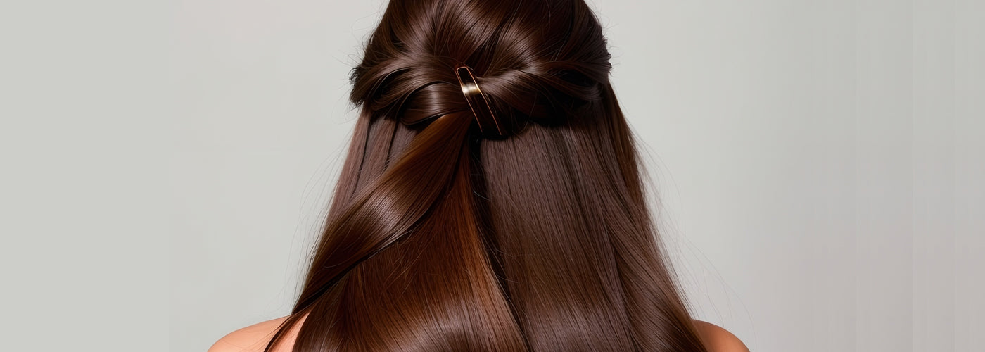 Woman parting her hair for clip-in extension installation