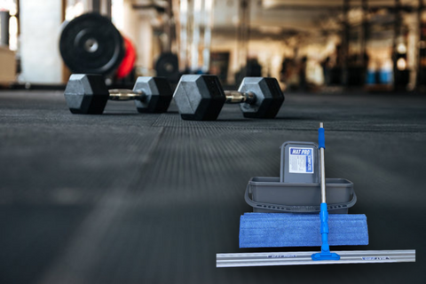 Deep cleaning process of gym mats for thorough sanitation.
