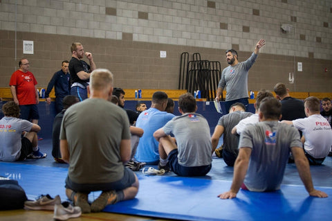 Wrestling team discussion emphasizing community support and open communication about health concerns.