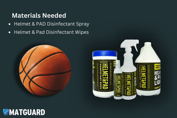 Assorted cleaning supplies laid out for basketball maintenance including Matguard disinfectant spray, wipes, a soft cloth, and a bowl of warm soapy water.