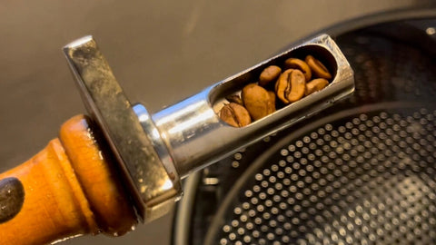 Coffee roaster sampler showing it contains roasted coffee.