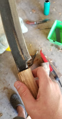 fitting the new wooden handle onto the parang machete blade