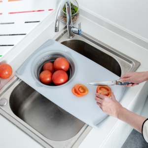 cutting tomatoes on over the sink cutting board