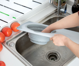 Washing tomatoes using an over the sink cutting board