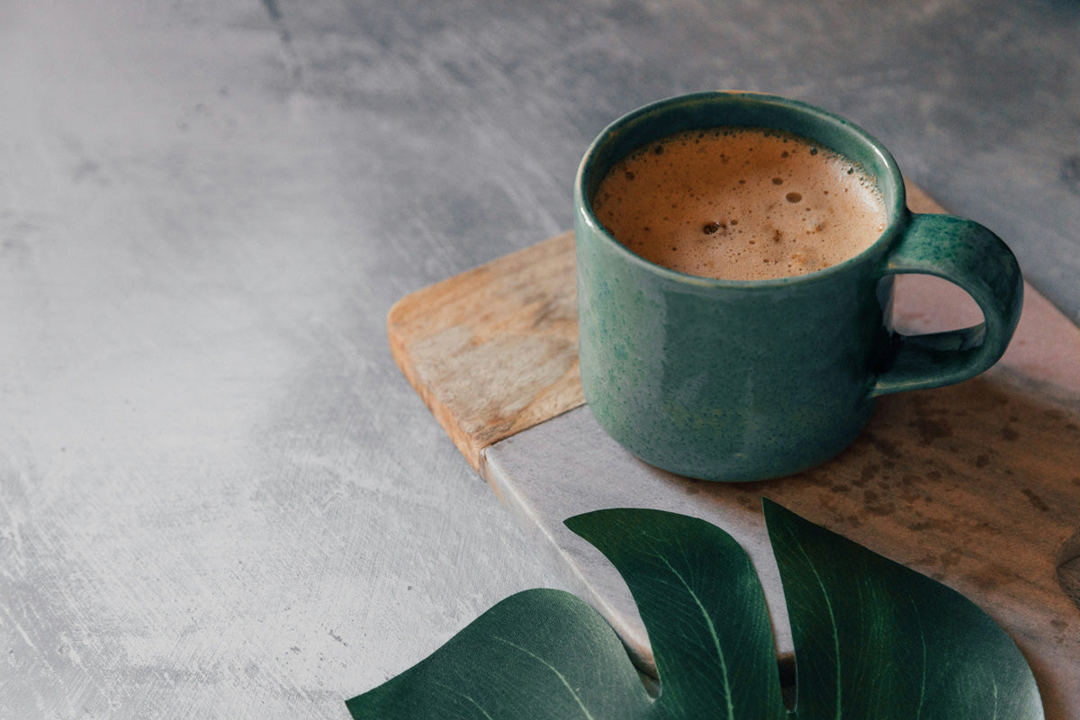 A scene of fika brewing Swedish medium-roasted coffee in a green mug