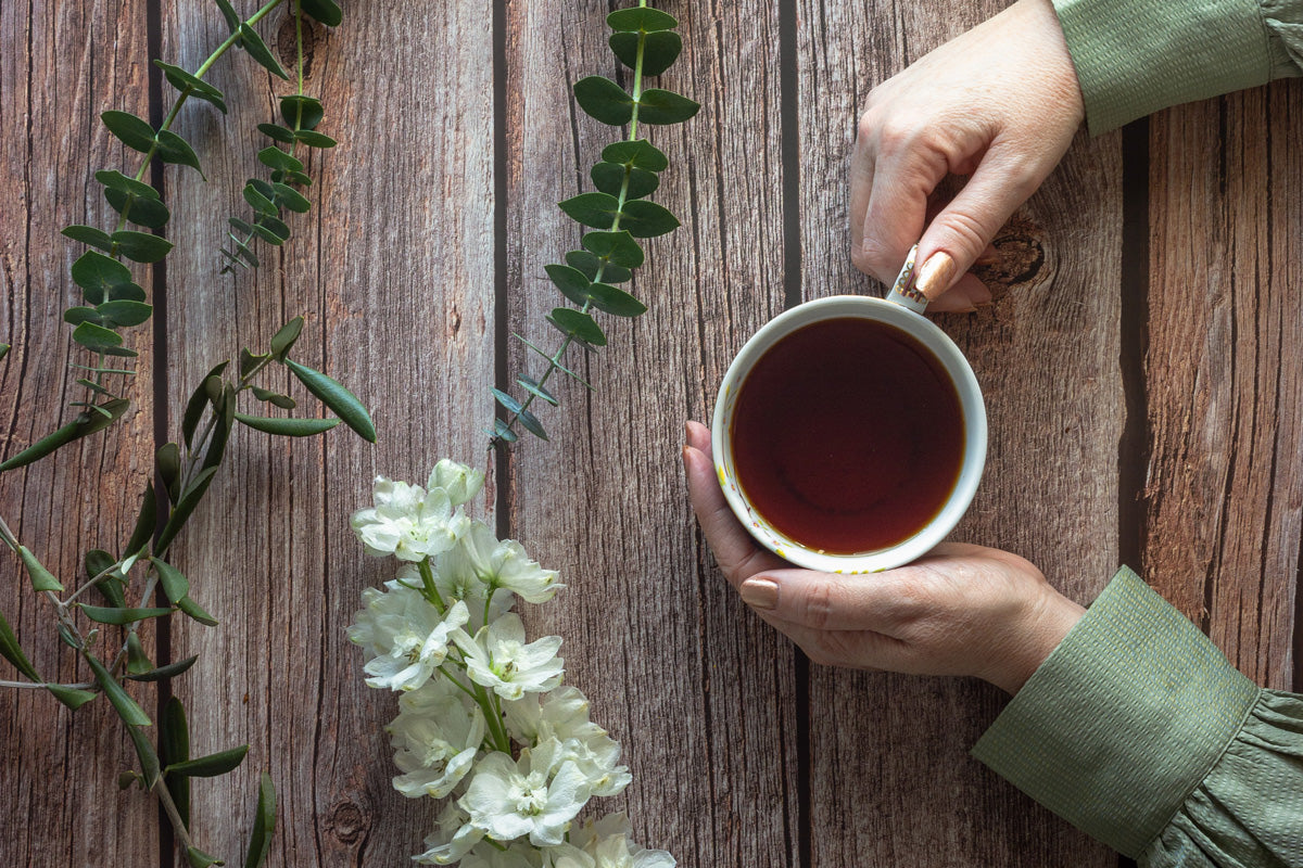 An image of pouring tea into a teacup and having fika