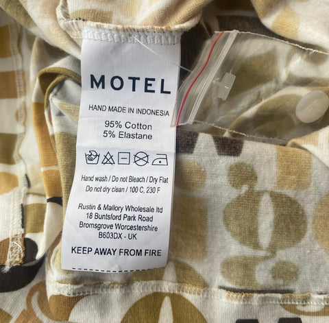 motel clothing care label showing the text instructions