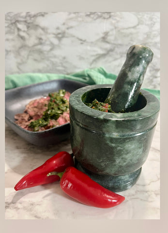 Making Chimichurri in the mortar and pestle