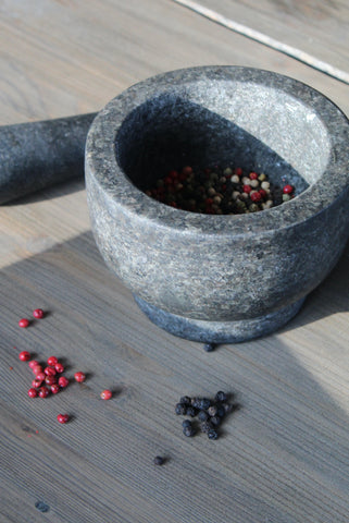 Peppercorns ready to grind with a mortar and pestle