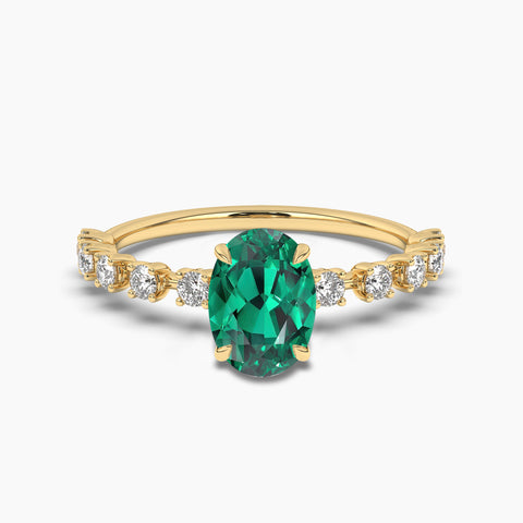 Oval cut Emerald side stone engagement ring