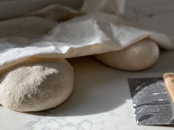 Preformed dough resting covered before the envelope fold