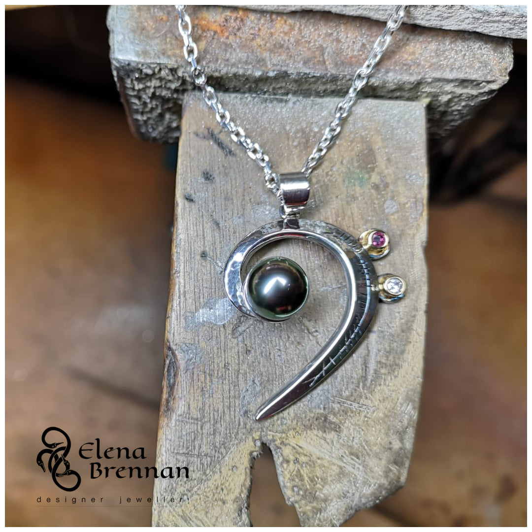 The finished Tahitian Black Pearl Pendant sitting on the bench in Elena's Jewellery Studio.