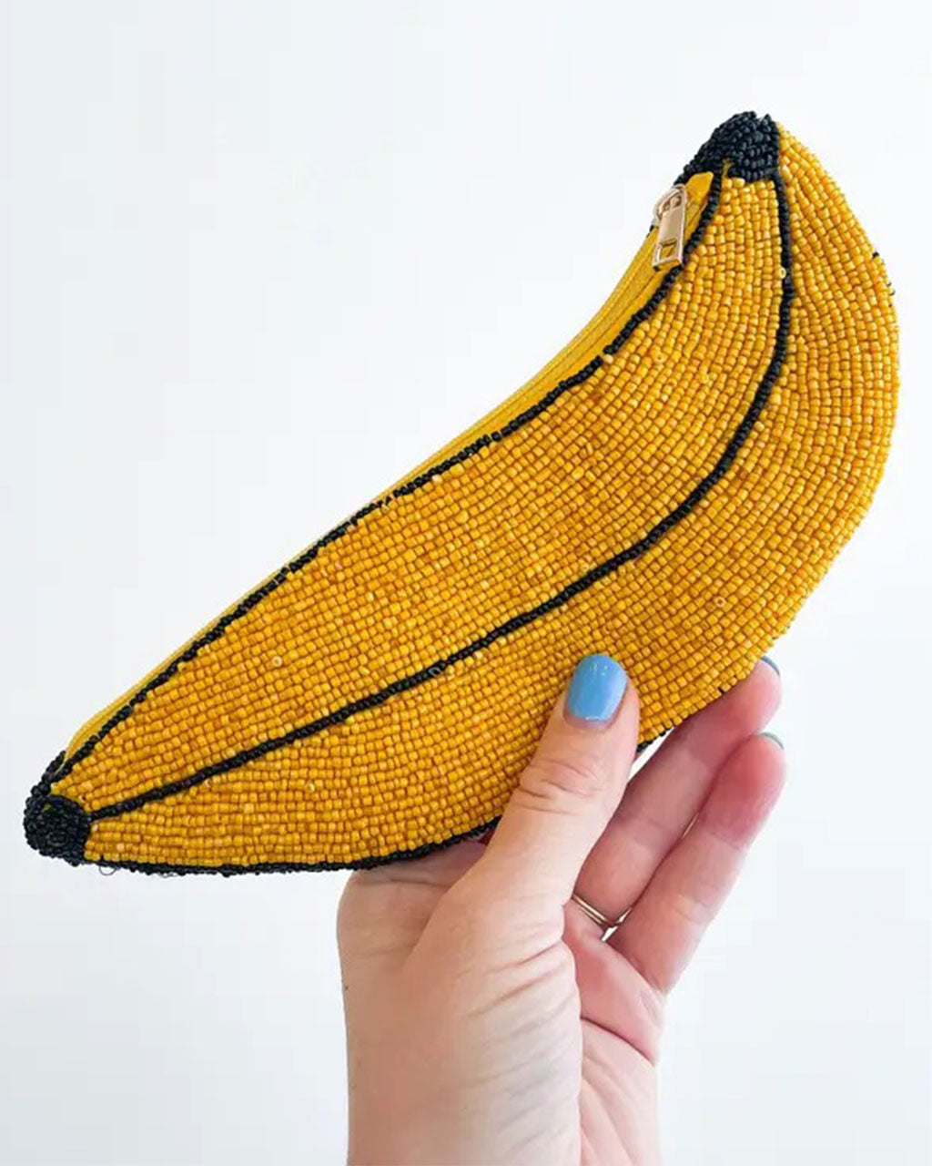 up close of model holding seed bead banana pencil pouch
