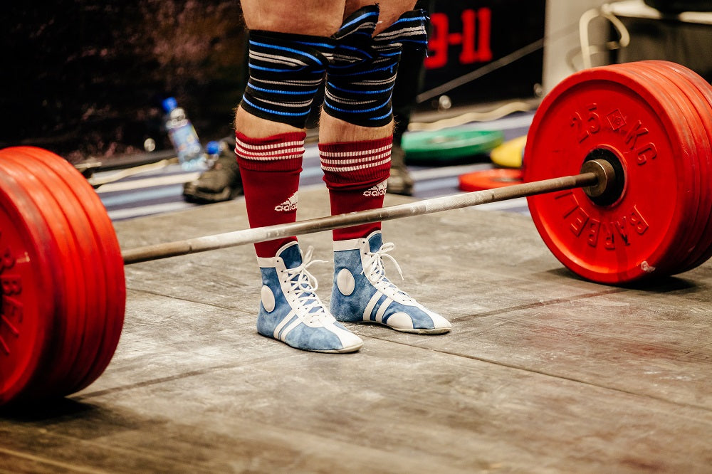 man using deadlifting shoes at competition
