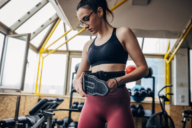 woman checking size of weightlifting belt