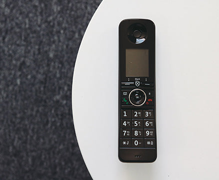 BT handset on white table