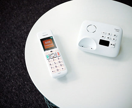 Gigaset E390A handset and base on white table