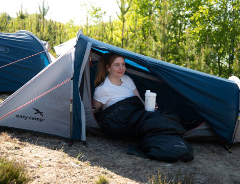 Woman sitting in Easy Camp Geminga tent