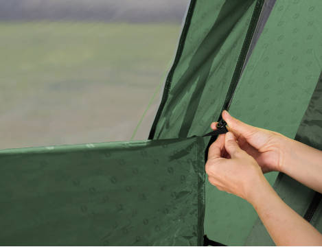 Person assembling green tent