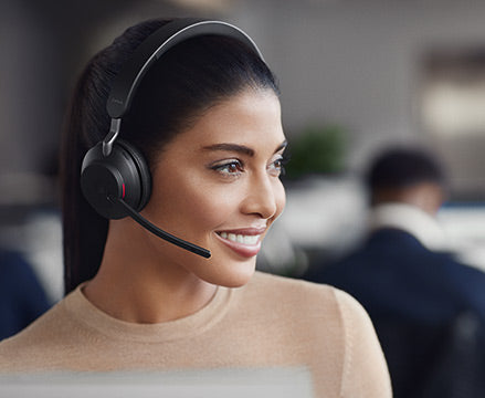 Smiling woman using headset