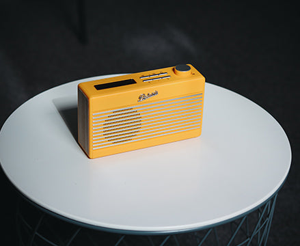 Yellow Roberts radio on coffee table