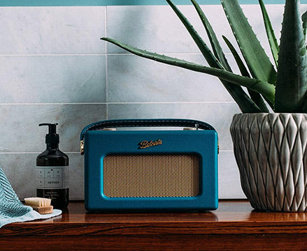 Teal Roberts Revival radio on bathroom shelf