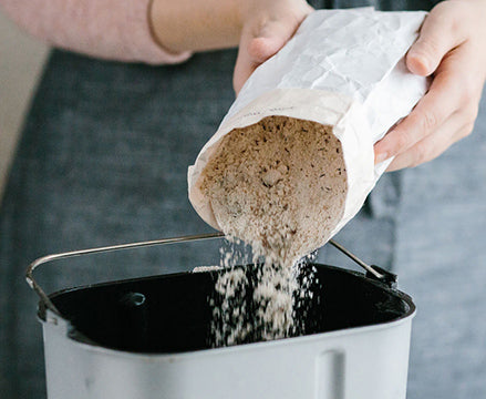Bread mix being poured into breadmaker
