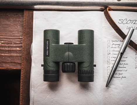 Hawke Nature-Trek compact binoculars on notebook