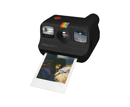 Black Polaroid camera printing photo