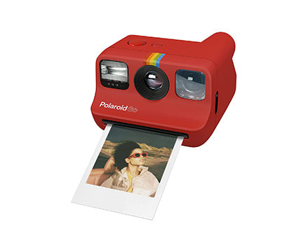 Red Polaroid camera printing photo