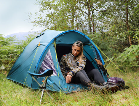 Woman sitting in Vango Alpha 400 tent