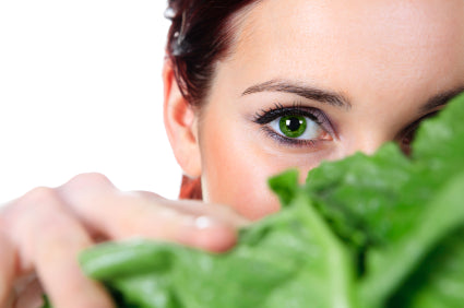 A woman peeping from the leafy green