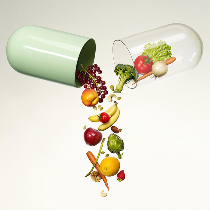 Fruits and vegetables falling from a pill