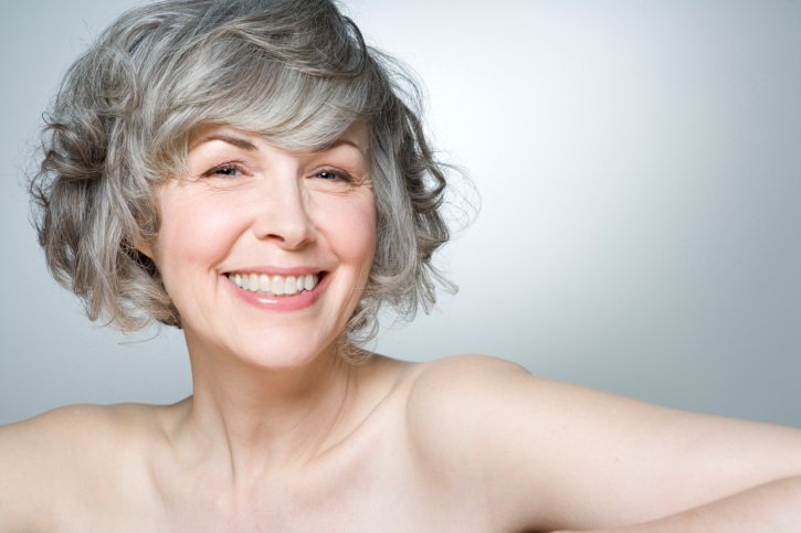 A smiling woman with grey hair