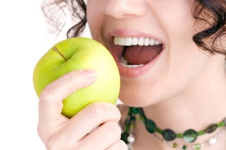 A woman eating an apple