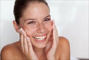 Girl scrubbing face with PureLx Micro-Dermabrasion Scrub