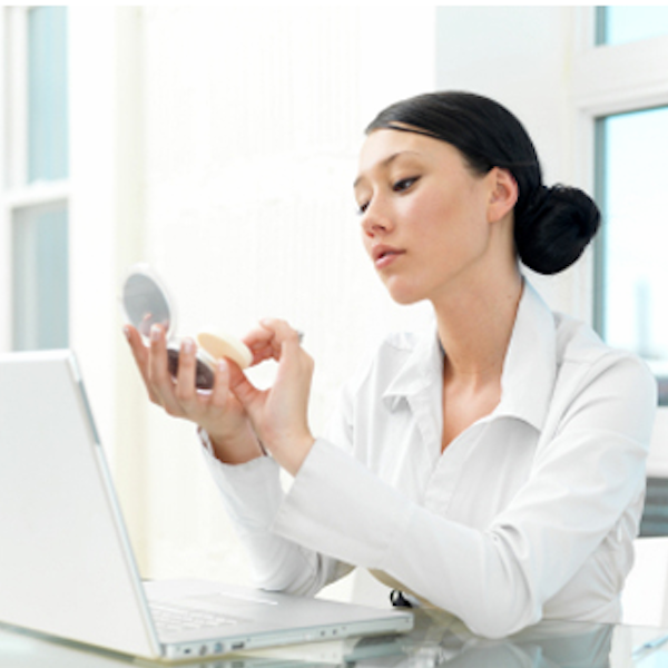 A girl doing makeup in the office