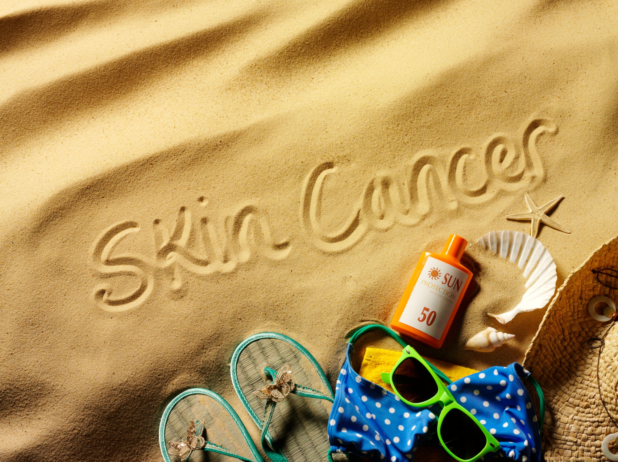 Sand with inscription and some beach things on it