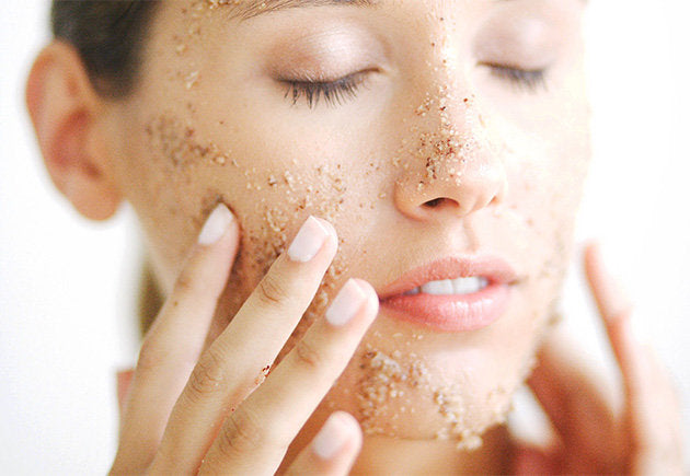 A woman scrubbing her face