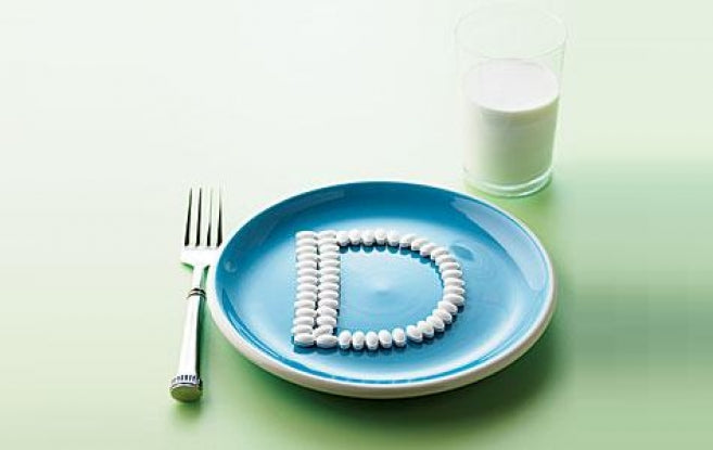 A letter "D"  lined with pills on a plate